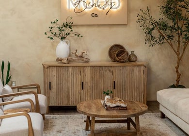 Relaxing lounge at Mood Beauty Co., Brant, Ontario, CA, with cozy chairs and greenery for a calming atmosphere.