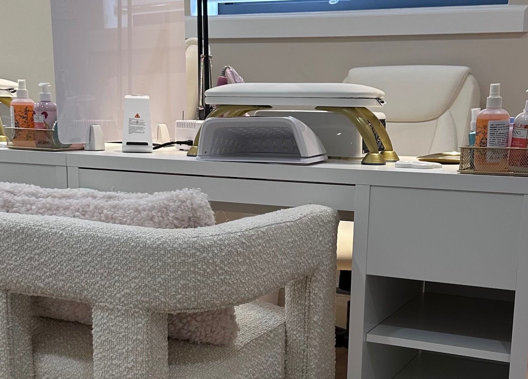 Modern nail station at Lilynailsmaster Carle Place, Carle Place, New York, US, featuring cozy seating and equipment.