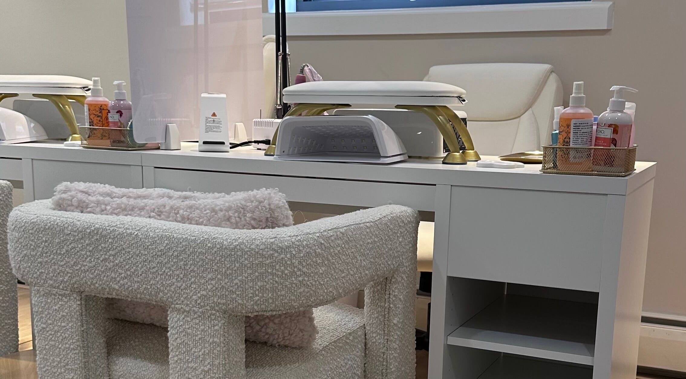 Modern nail station at Lilynailsmaster Carle Place, Carle Place, New York, US, featuring cozy seating and equipment.