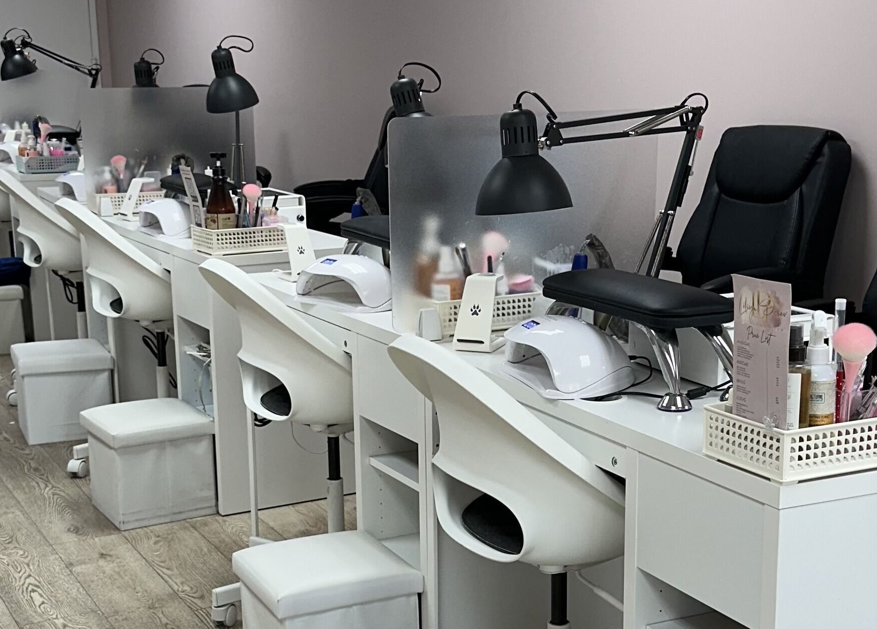 Modern nail service stations at Lilynailsmaster Forest Hills in New York, New York, US, with sleek white decor.