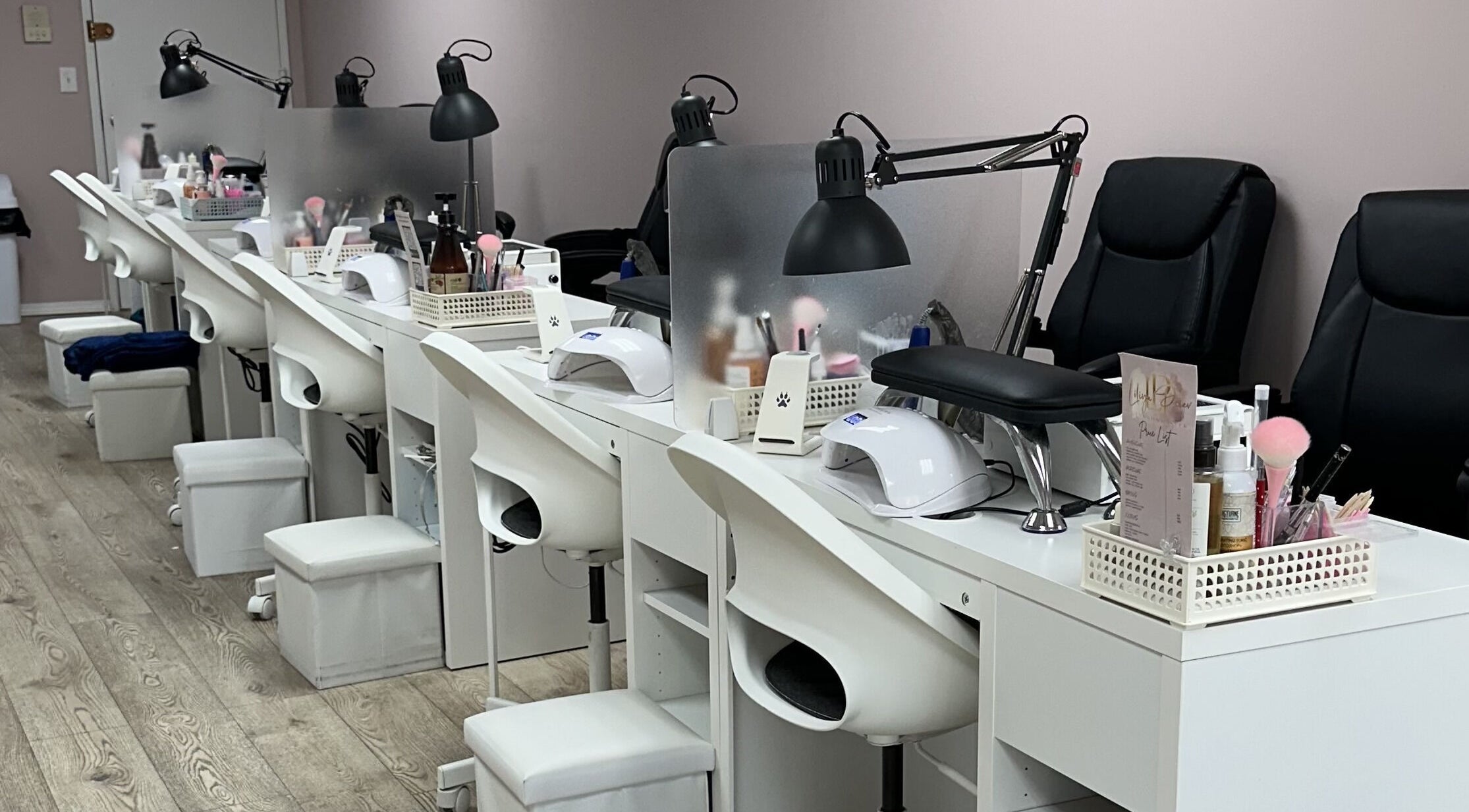 Modern nail service stations at Lilynailsmaster Forest Hills in New York, New York, US, with sleek white decor.