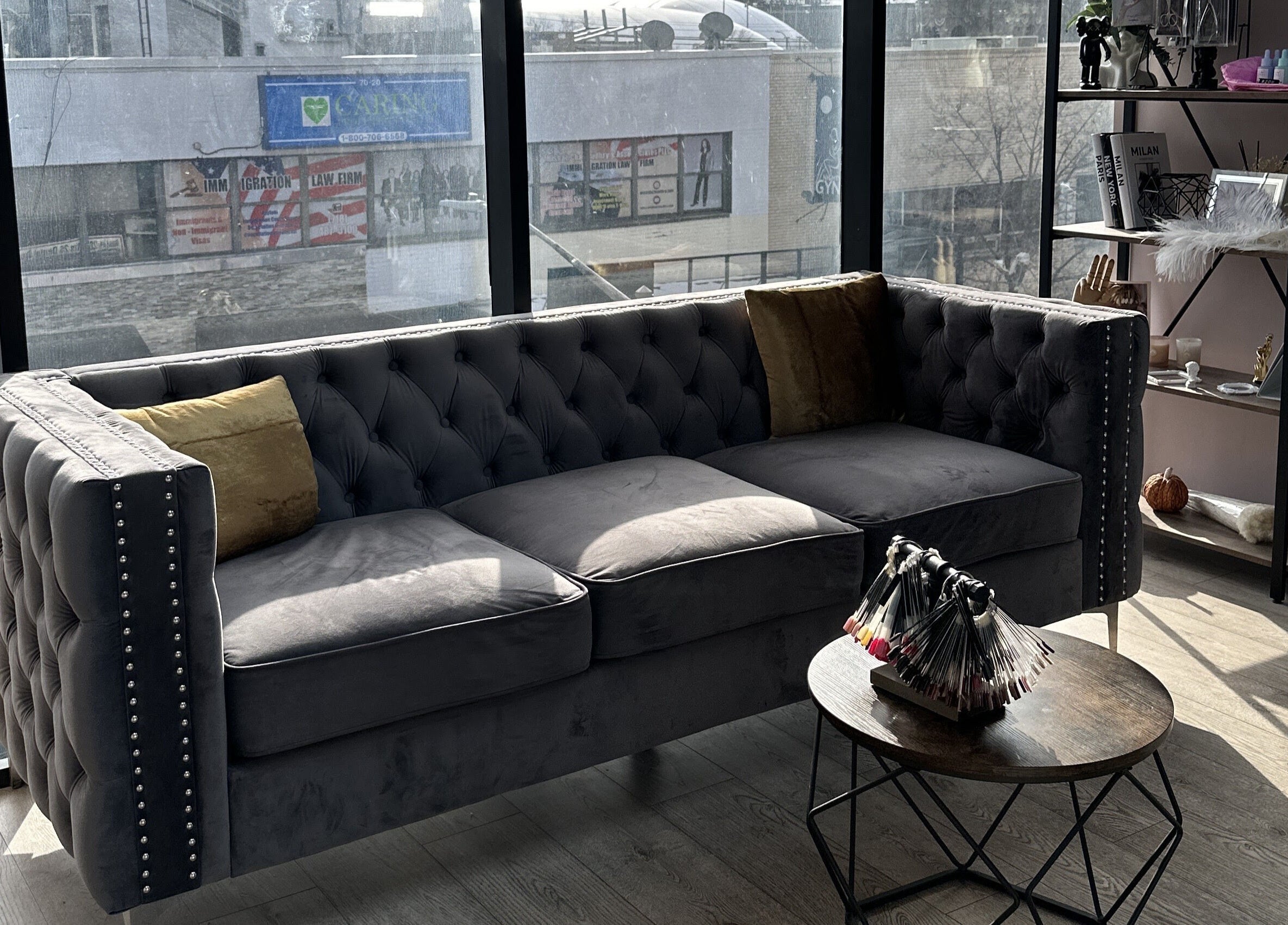 Elegant sofa in Lilynailsmaster Forest Hills, New York, New York, US, with natural light from large windows.