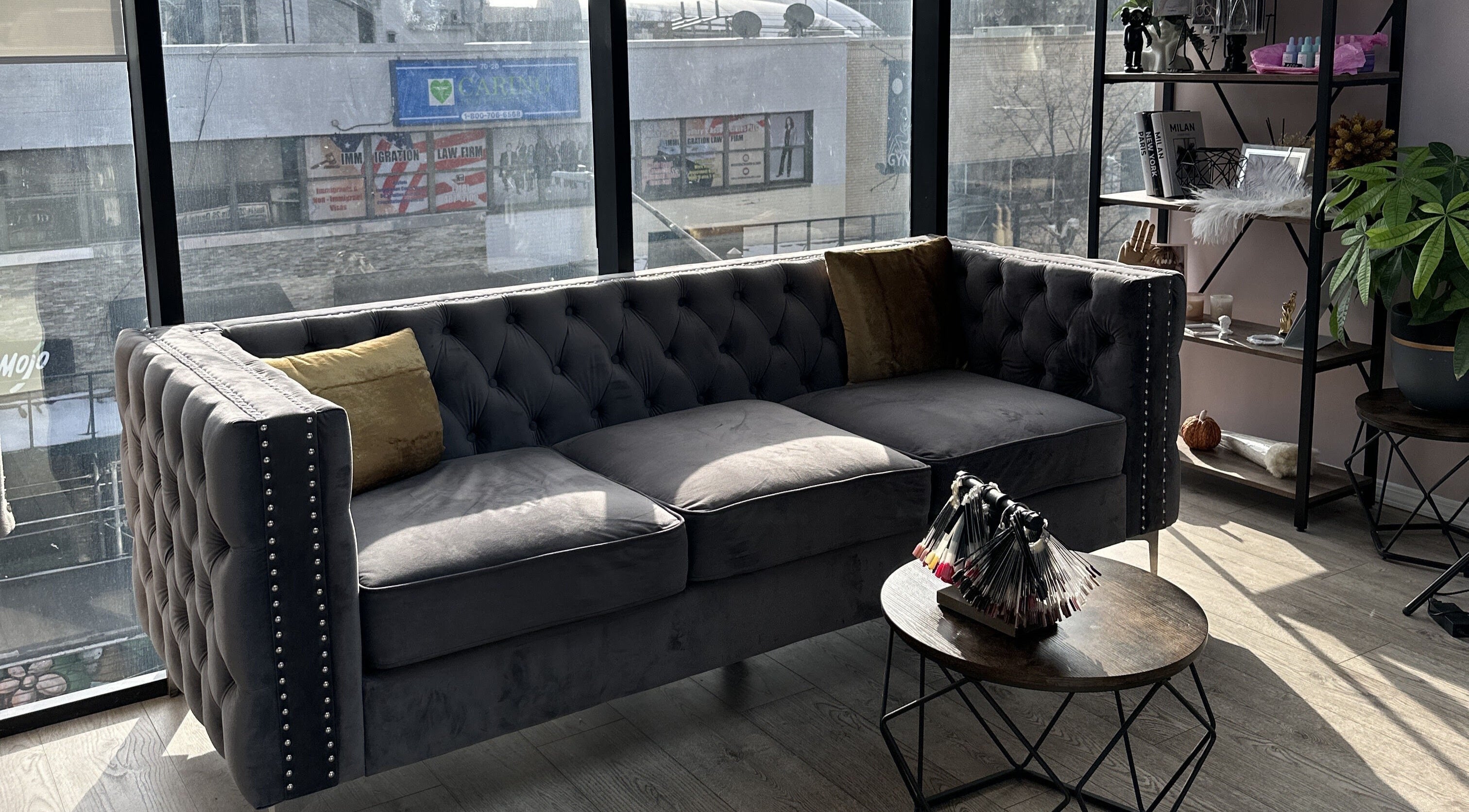 Elegant sofa in Lilynailsmaster Forest Hills, New York, New York, US, with natural light from large windows.