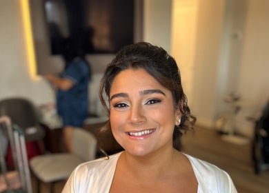 Elegant makeup at Salon Posh & DeCara Makeup, Mamaroneck, New York, US. A smiling woman showcases refined beauty.