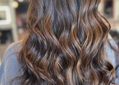 Luxurious wavy brown hairstyle from Salon Posh & DeCara Makeup, Mamaroneck, New York, US.