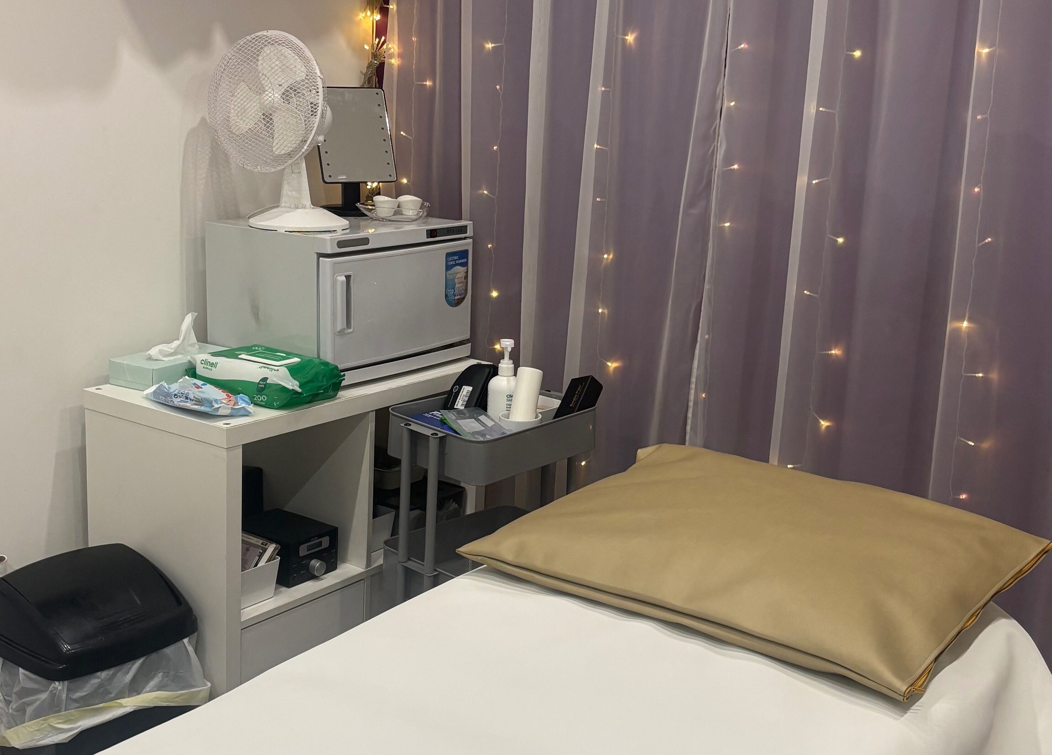 Cozy treatment room at Rainbows and Dreams Beauty, Watford, England, GB with gentle lighting and soft furnishings.