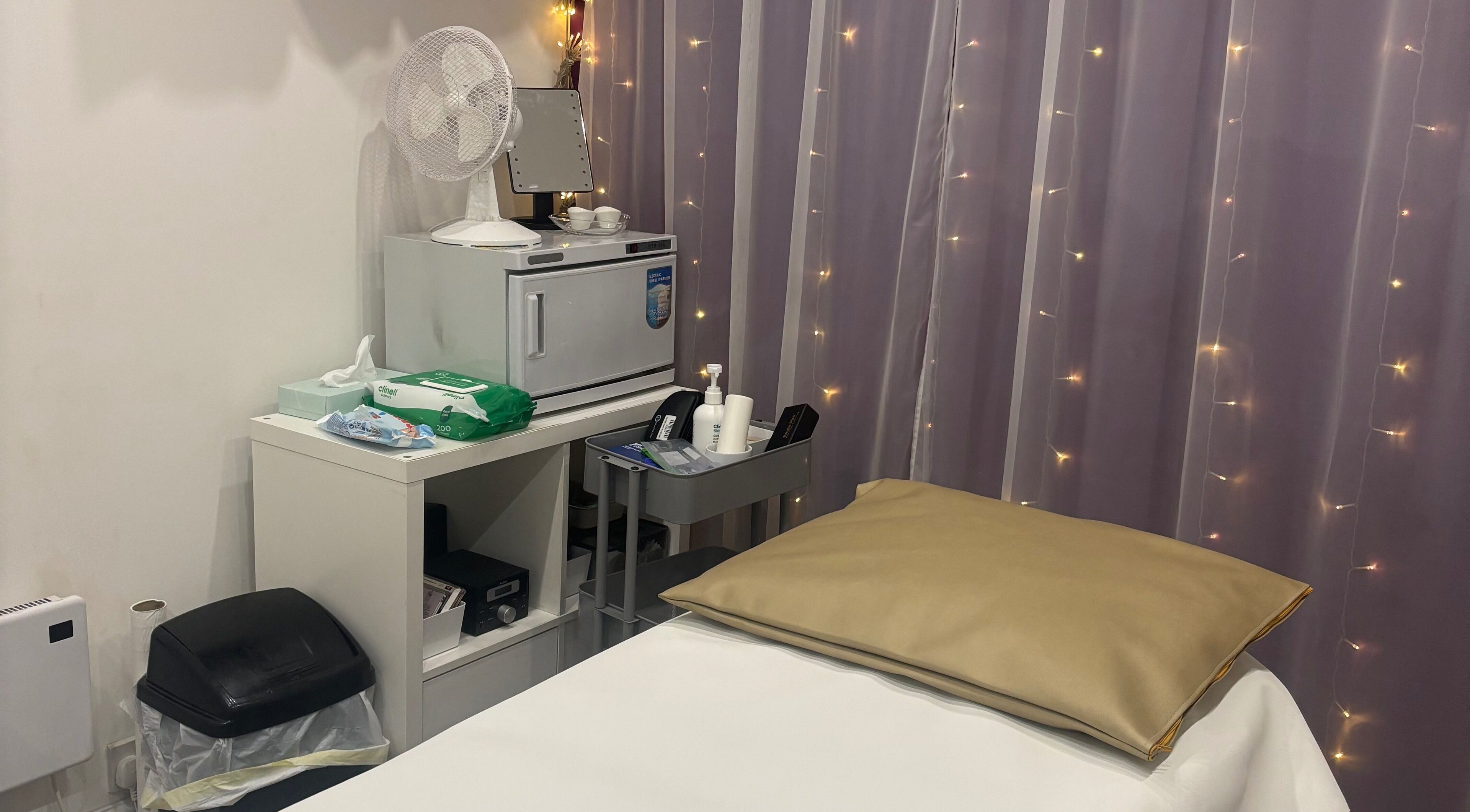 Cozy treatment room at Rainbows and Dreams Beauty, Watford, England, GB with gentle lighting and soft furnishings.