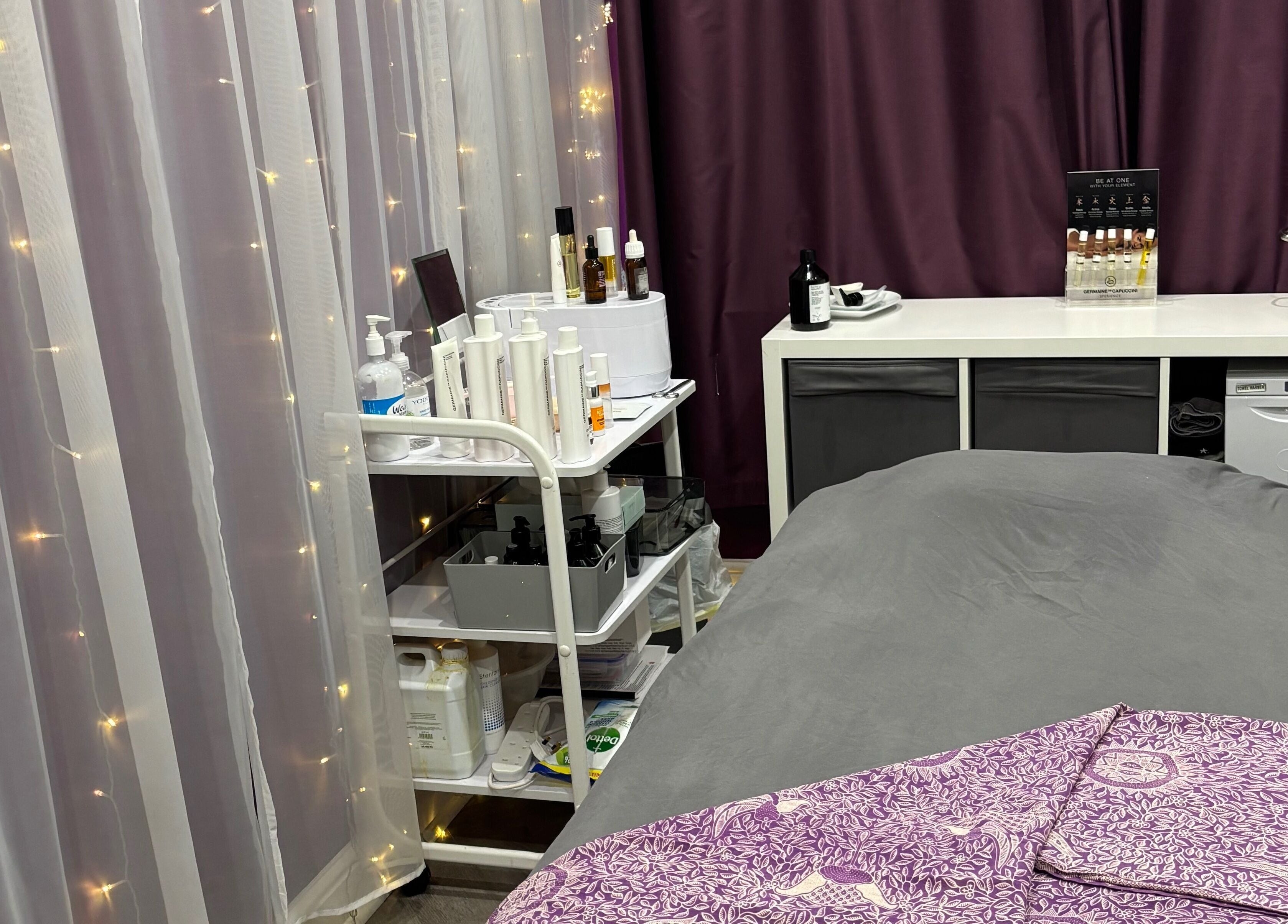 Tranquil spa room at Rainbows and Dreams Beauty, Watford, England, GB with massage bed and beauty products.