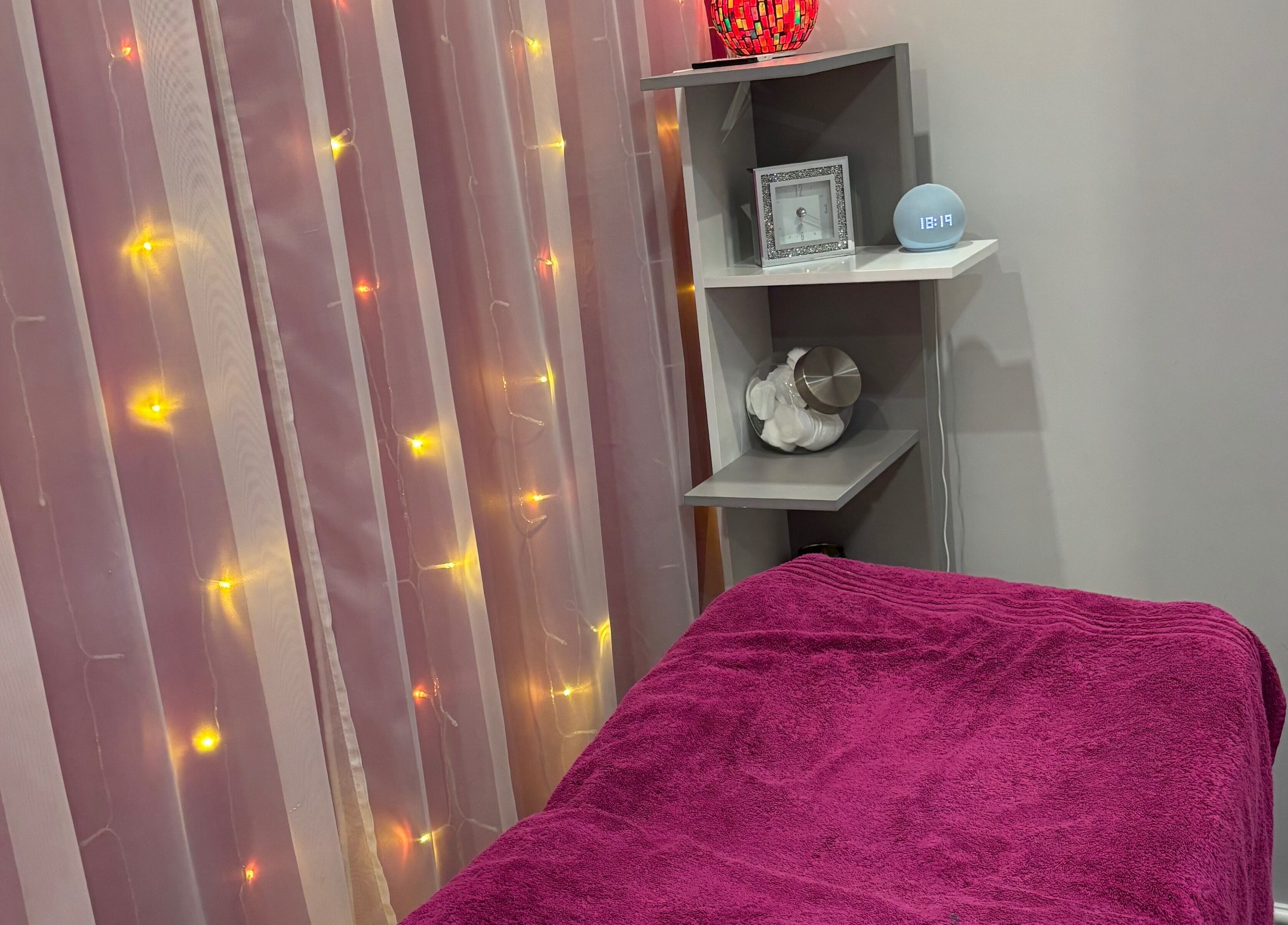 Cozy treatment room at Rainbows and Dreams Beauty in Watford, England, GB with ambient fairy lights.