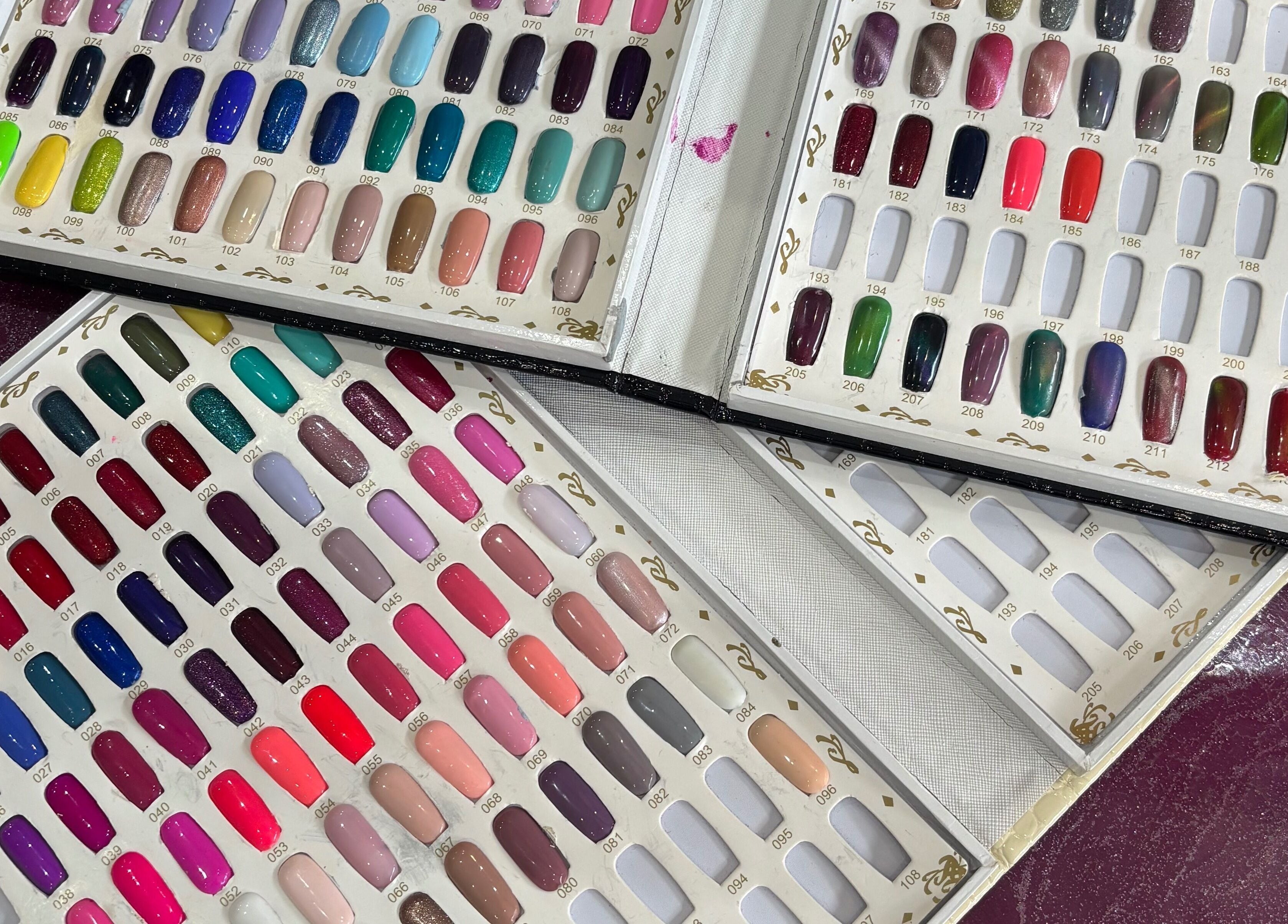 Colorful nail polish palette at Rainbows and Dreams Beauty in Watford, England, GB showcasing vibrant choices.