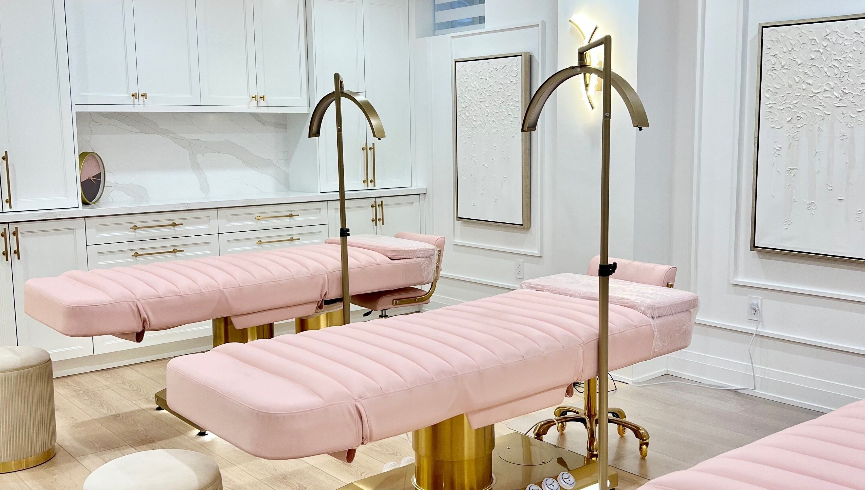 Elegant interior of Lash Layer and Brow Boutique in Pickering, Ontario, CA featuring plush pink treatment beds.