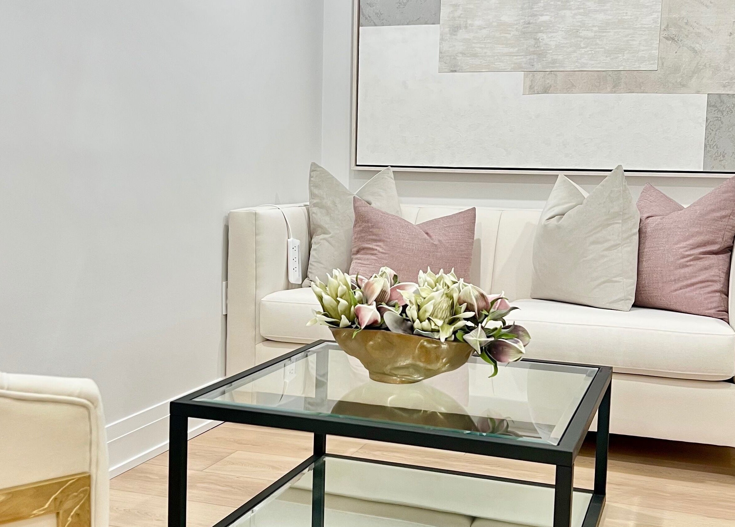 Cozy waiting area at Lash Layer and Brow Boutique, Pickering, Ontario, CA with plush sofa and floral decor.