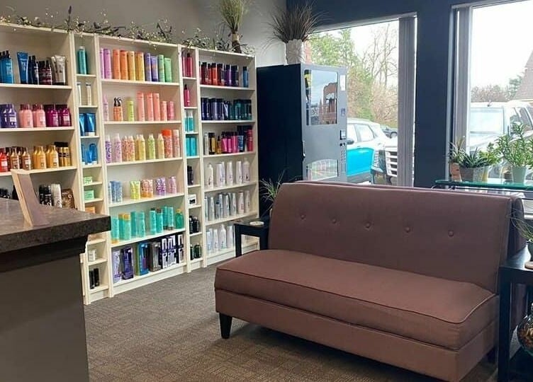 Cozy reception area at Changes Hair Design, Meridian Charter Township, Michigan, with shelves of hair products.