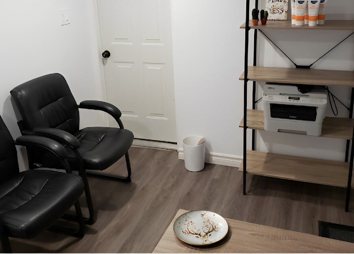 Welcoming seating area at The Sugary, Peterborough, Ontario, CA featuring leather chairs and a wooden shelf.