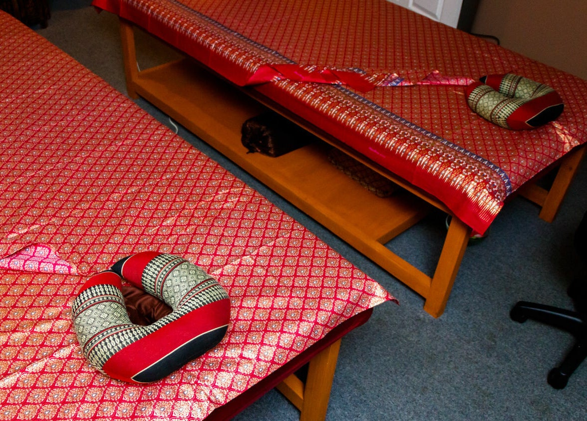 Elegant massage tables with Thai decor at Thai Villa Spa, Newton, Massachusetts, US.