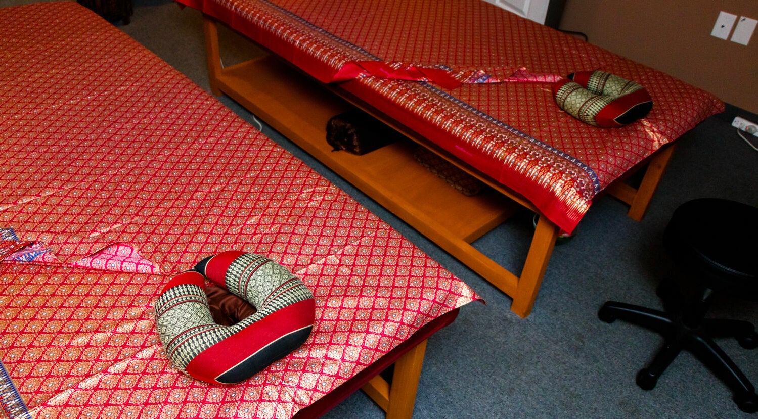 Elegant massage tables with Thai decor at Thai Villa Spa, Newton, Massachusetts, US.