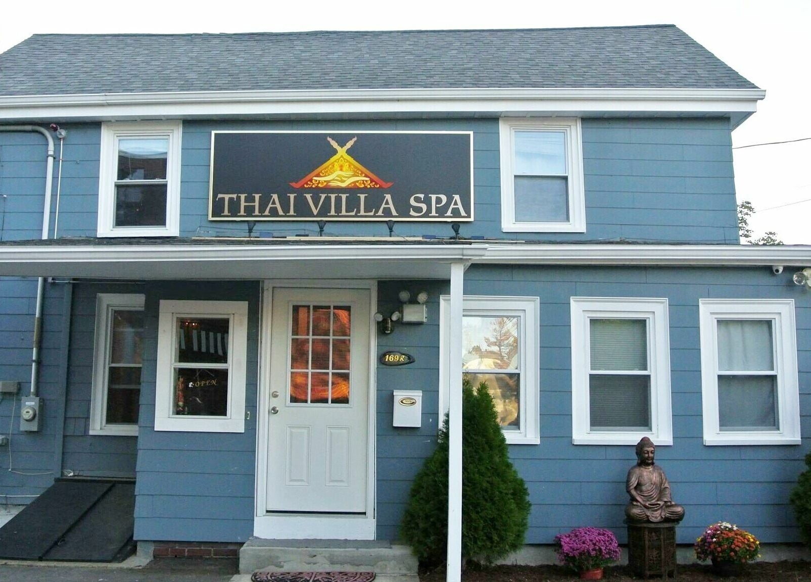 Front view of Thai Villa Spa with charming blue exterior in Newton, Massachusetts, US.