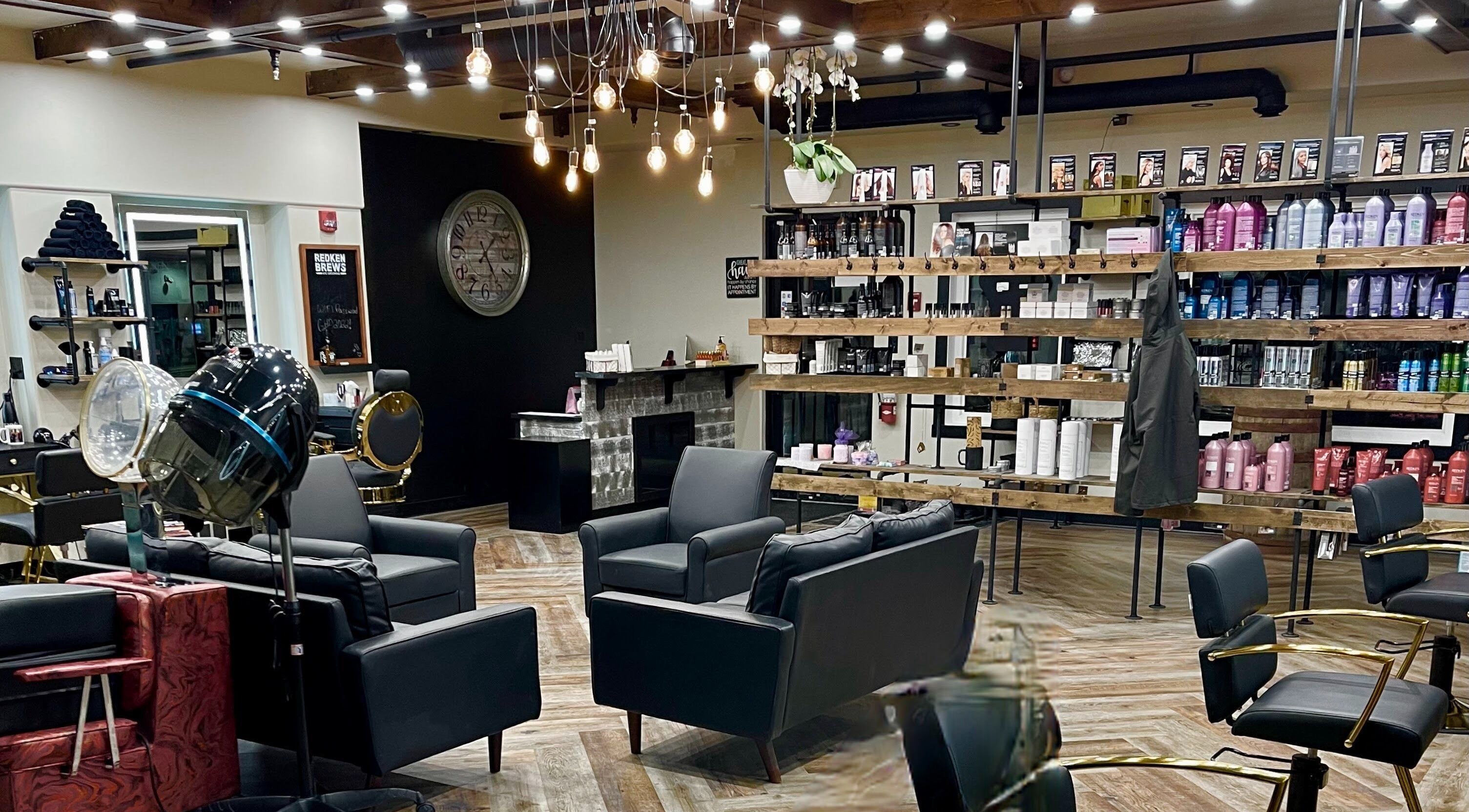 Interior of Guitar Hair Dezigns & Esthetics Abasand in Fort McMurray, Alberta, CA, showcasing modern seating and decor.