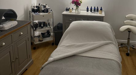 Treatment room at The Norfolk Beauty Rooms, North Walsham, England, GB, featuring a spa bed and skincare products.