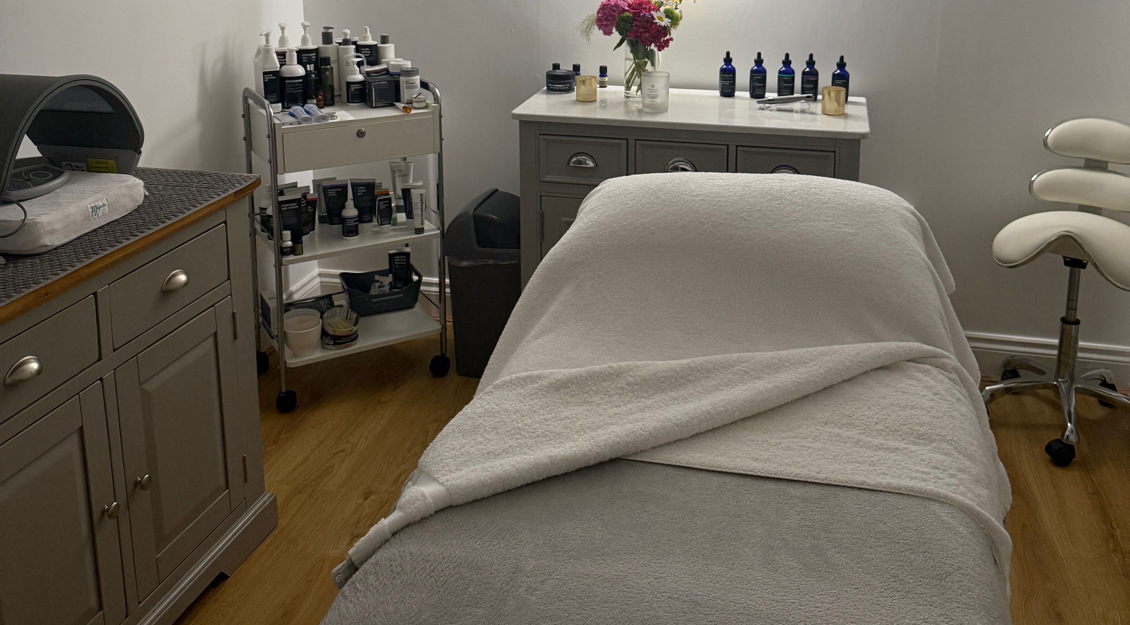 Treatment room at The Norfolk Beauty Rooms, North Walsham, England, GB, featuring a spa bed and skincare products.