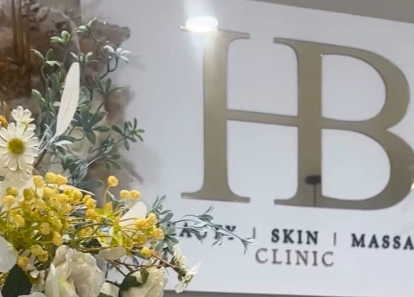 Floral arrangement at Genesis Skin & Beauty, Barrow, England, GB with clinic signage in the background.