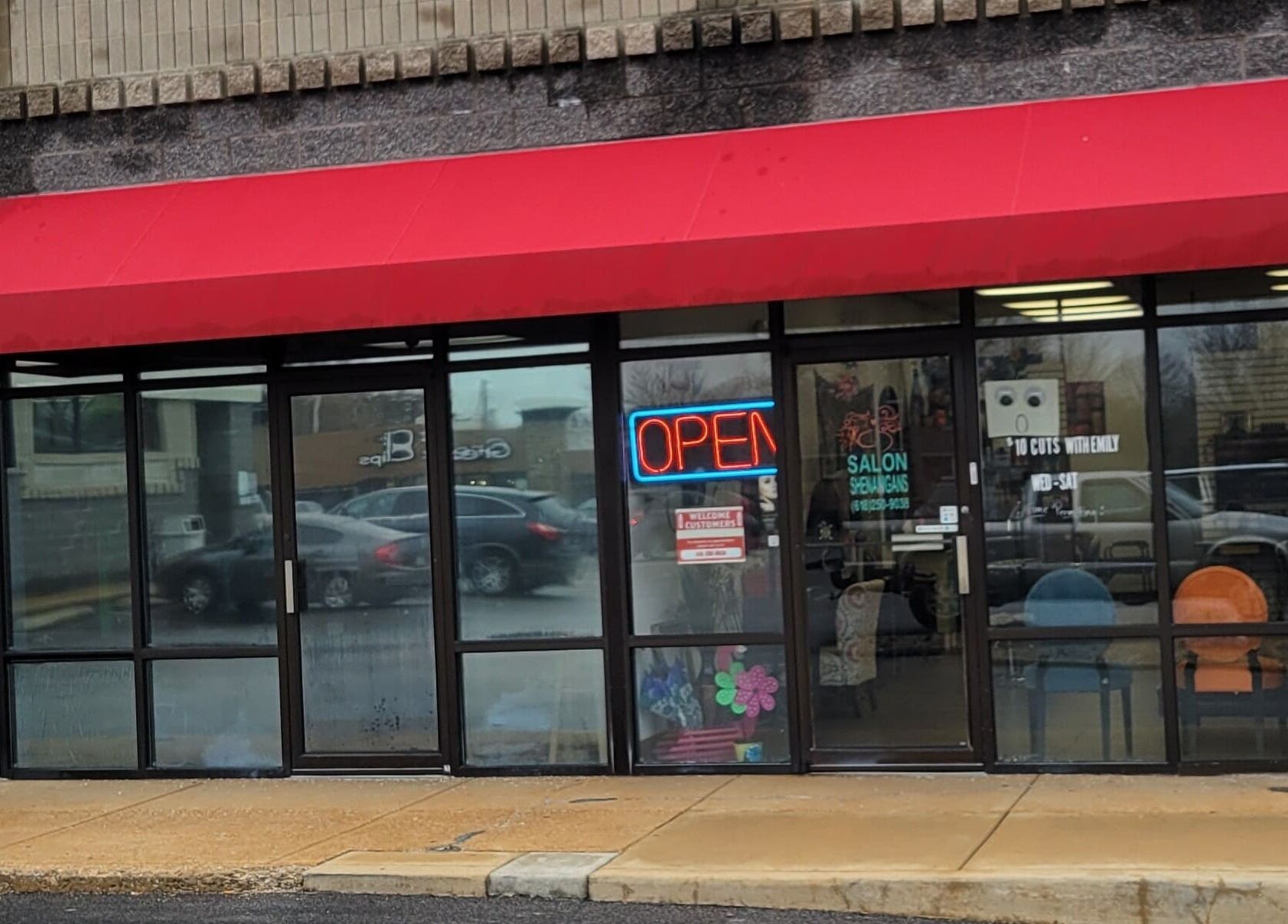 Front view of Salon Shenanigans LLC with red awning in St. Louis, Missouri, US.