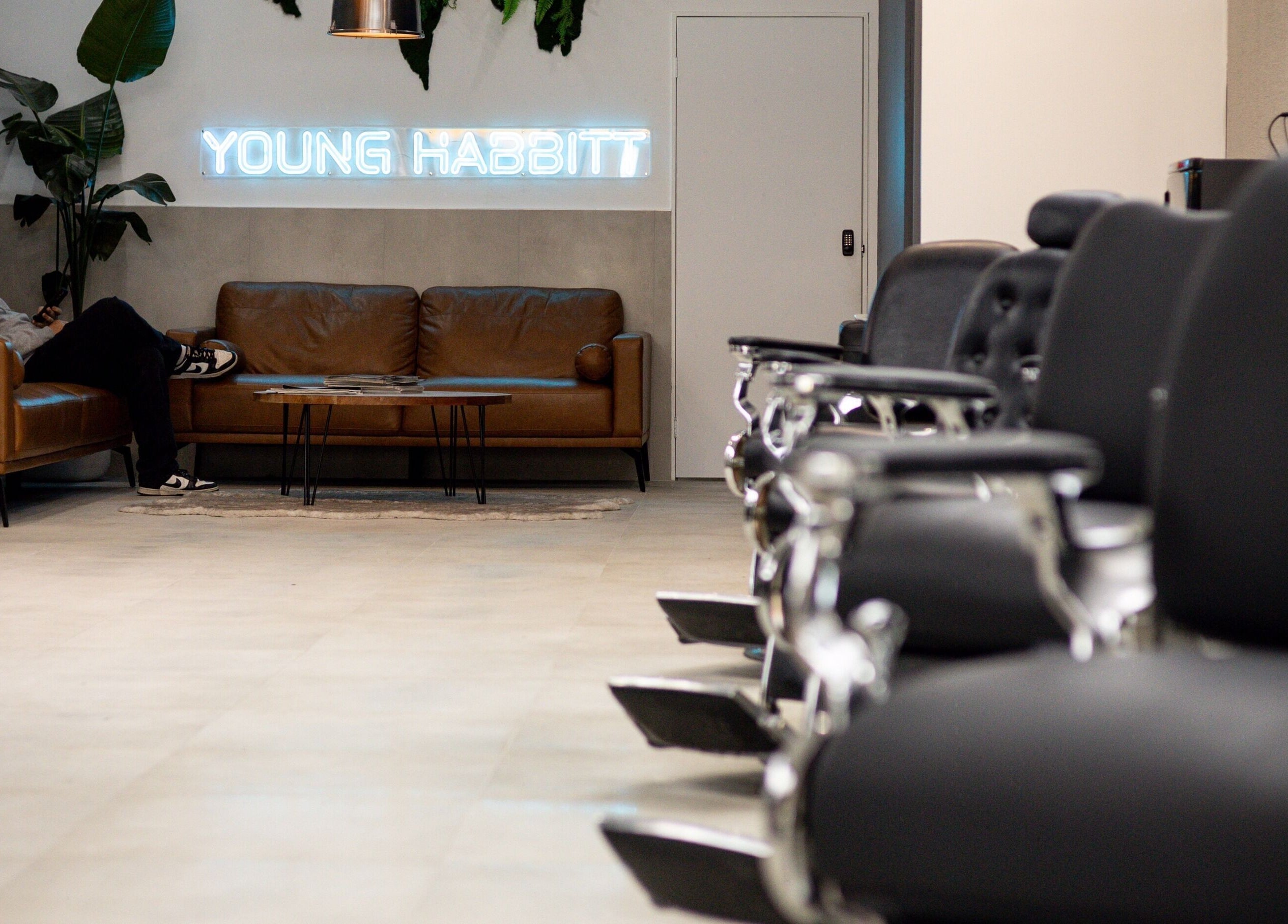 Modern seating area in Young Habbitt Barbers - Werribee, Melbourne, Victoria, AU with stylish chairs.