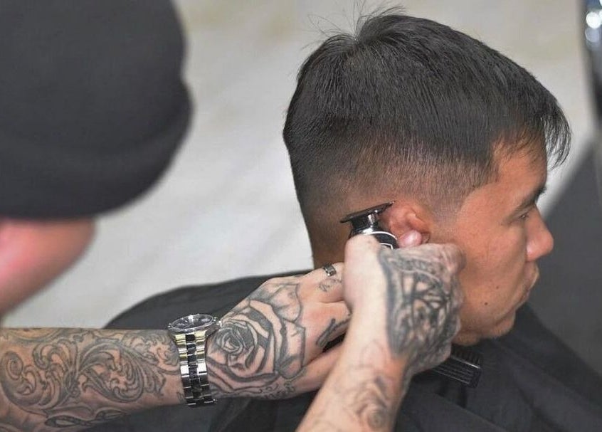 Barber giving a detailed haircut at Young Habbitt Barbers - Werribee, Melbourne, Victoria, AU.