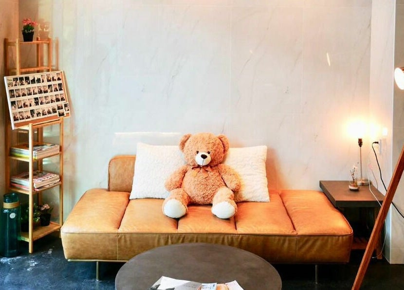 Inviting lounge area with plush teddy at Vsalon, Vancouver, British Columbia, CA.