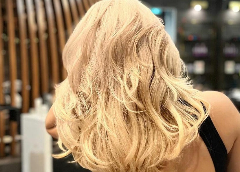 Elegant blonde hair waves in Vsalon, Vancouver, British Columbia, CA, showcasing vibrant style and luxury.