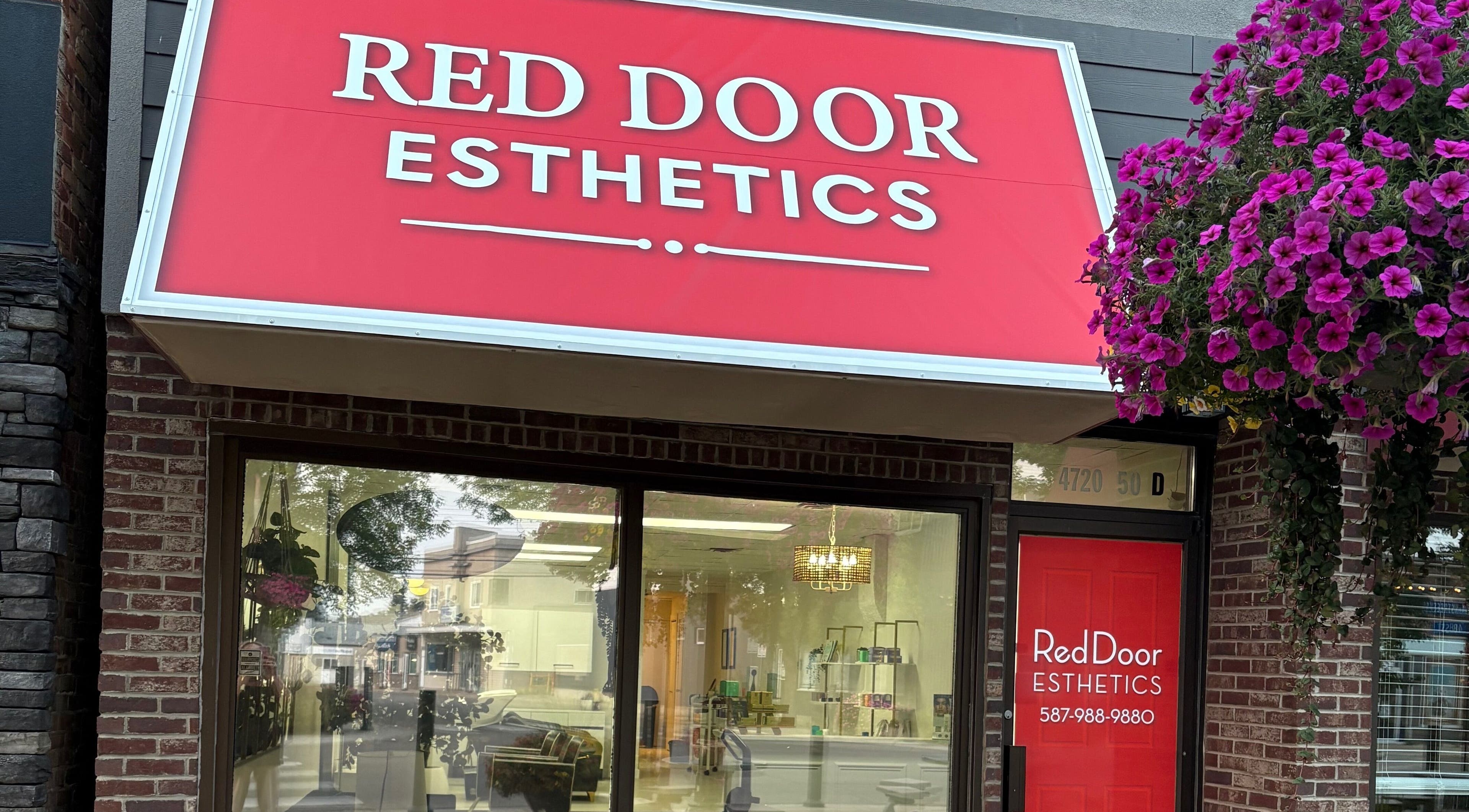 Red Door Esthetics storefront with vibrant flowers in Leduc, Alberta, CA.