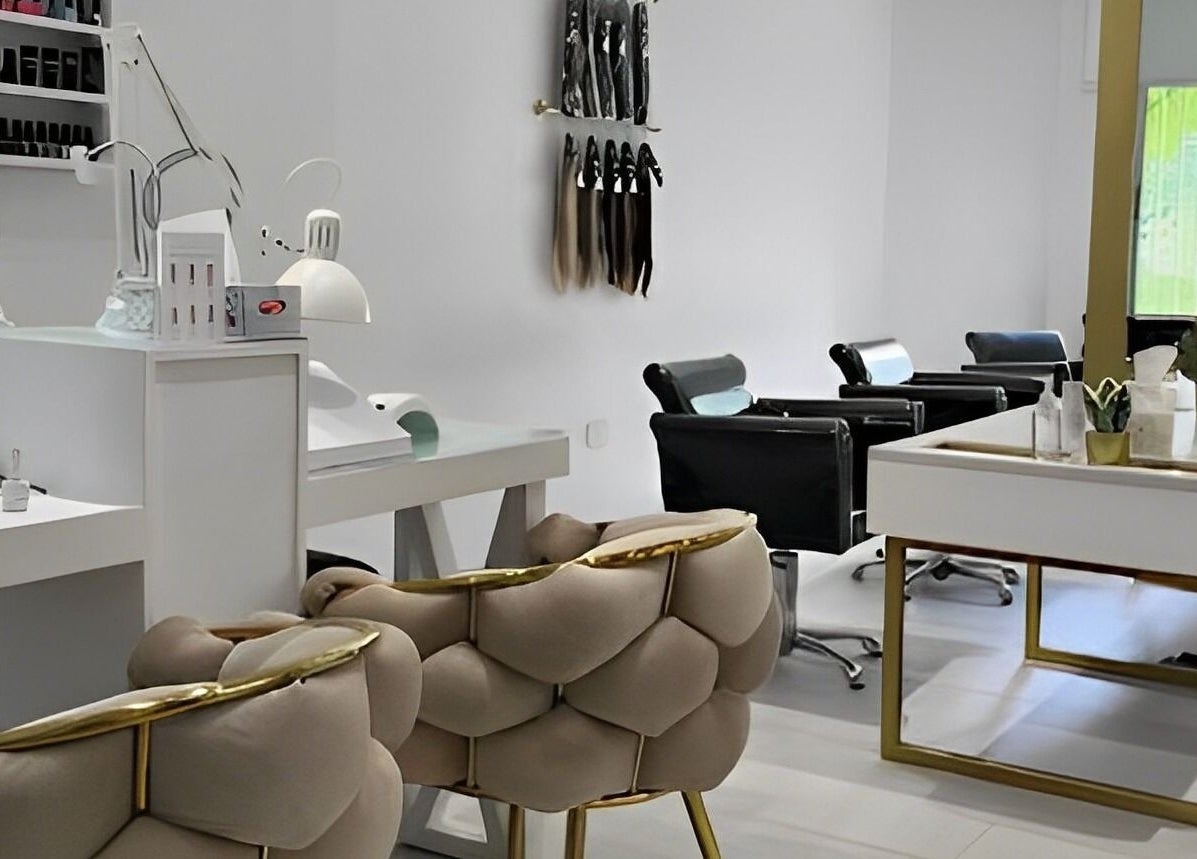 Modern interior of The Muse Salon in Manama, Muḥāfaẓat al-ʿĀṣimah, BH showcasing stylish chairs and workstations.
