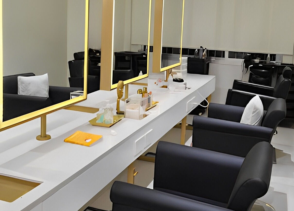 Modern interior of The Muse Salon in Manama, Muḥāfaẓat al-ʿĀṣimah, BH with stylish salon chairs and elegant mirrors.