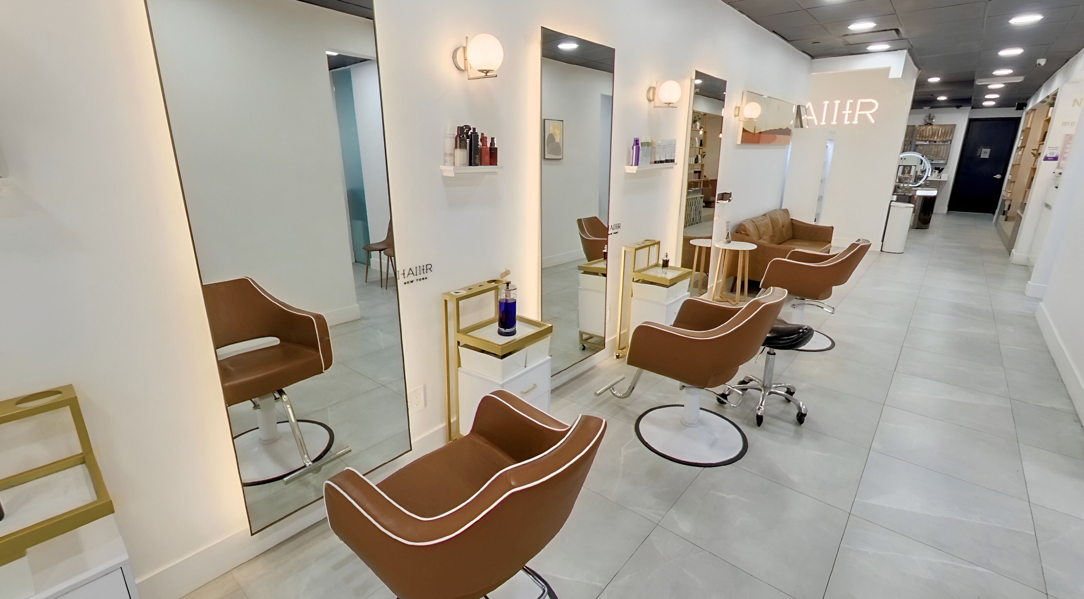 Modern interior of HAIIER SALON [Flushing], New York, New York, US with sleek chairs and well-lit mirrors.