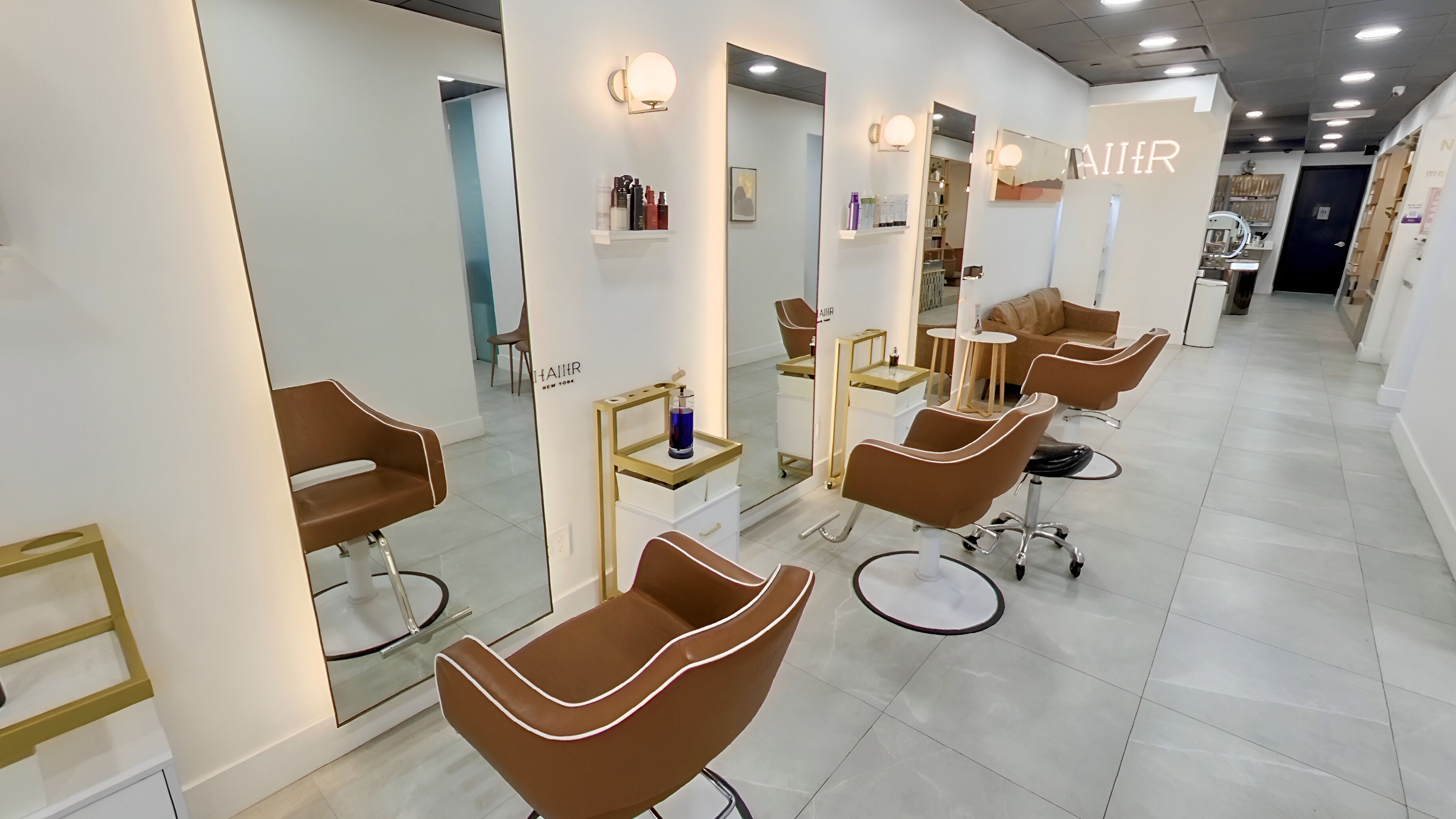 Modern interior of HAIIER SALON [Flushing], New York, New York, US with sleek chairs and well-lit mirrors.