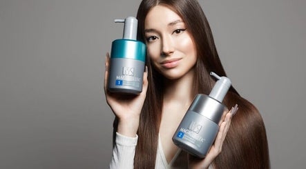 A woman showcasing hair products at HAIIER SALON - Freelance, New York, New York, US.