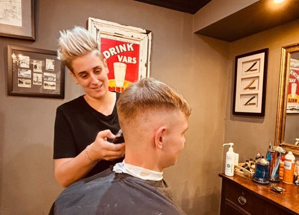A barber styling a customer's hair at Kuif & Baard Barbershop in Pretoria, Gauteng, ZA.