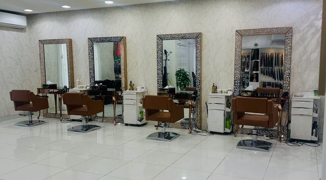 Chic styling stations at Namika Beauty Salon and Spa, Doha, Doha, QA with elegant mirrors and plush chairs.