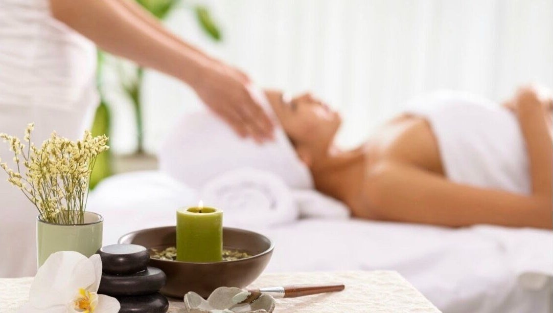 Relaxing spa therapy at DermaLook Aesthetics, Toronto, Ontario, CA, with candles and a serene atmosphere.