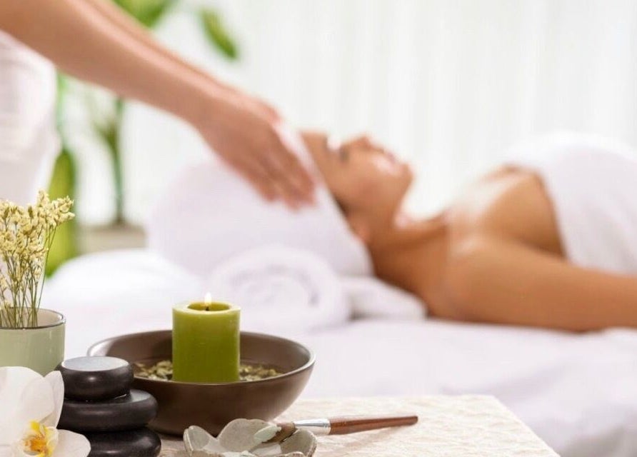 Relaxing spa therapy at DermaLook Aesthetics, Toronto, Ontario, CA, with candles and a serene atmosphere.