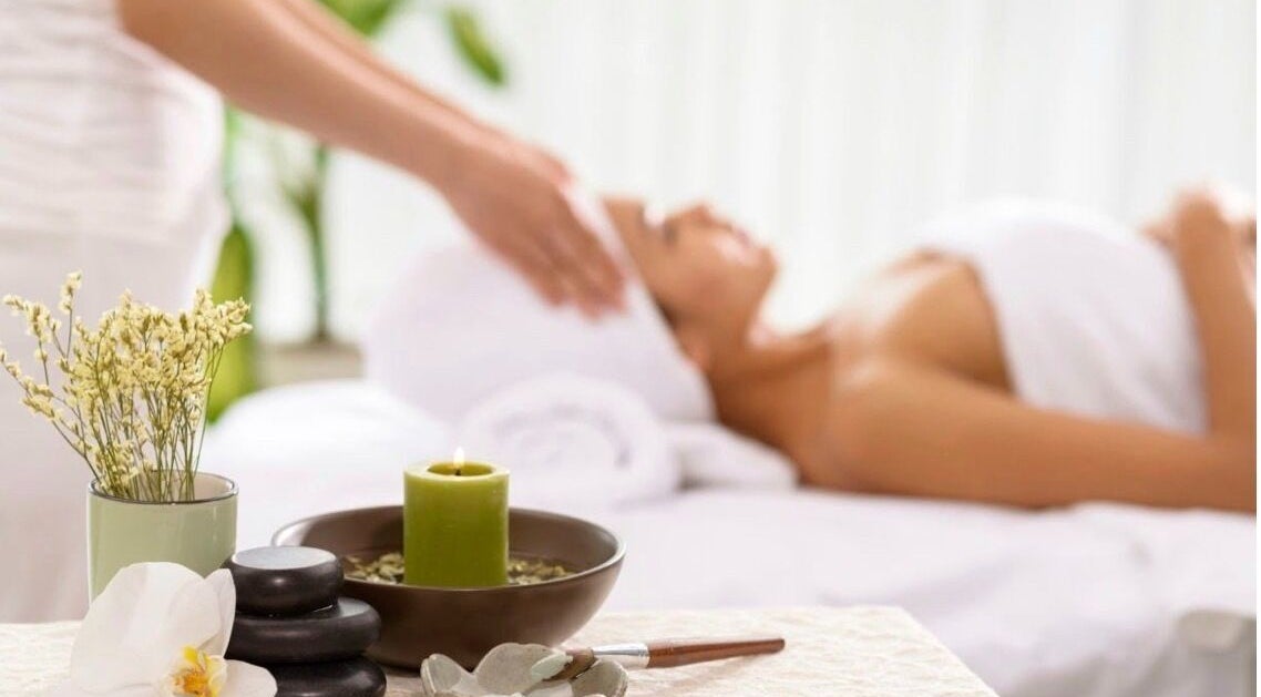 Relaxing spa therapy at DermaLook Aesthetics, Toronto, Ontario, CA, with candles and a serene atmosphere.