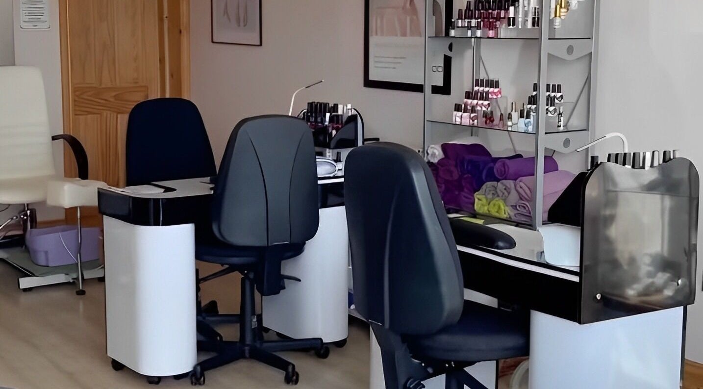 Nail care station at Barnham Health and Beauty in Barnham, England, GB, showing chairs and polish display.