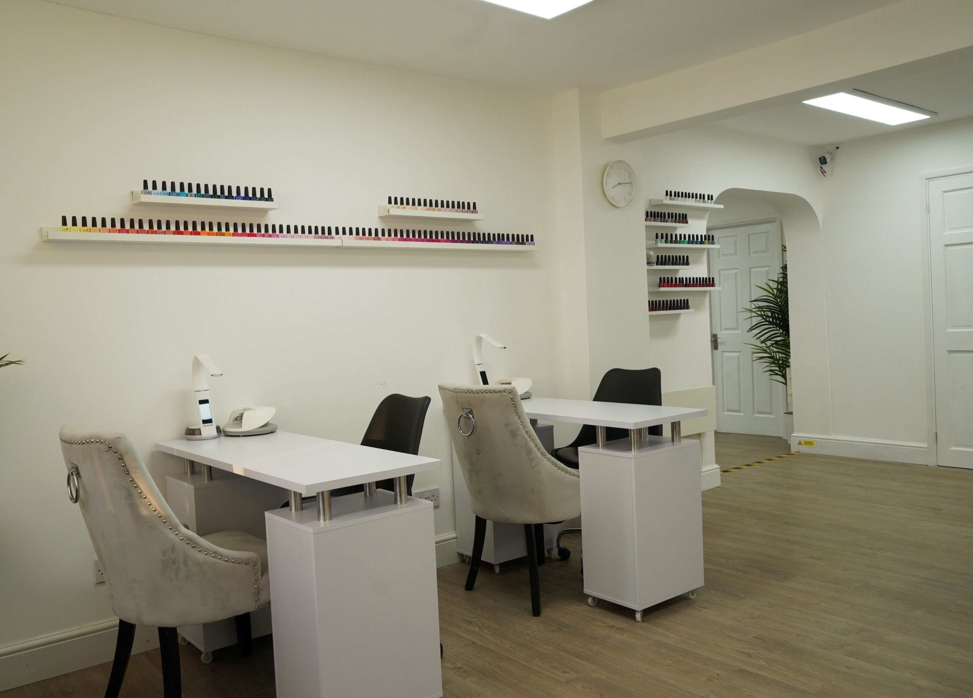 Nail salon interior at Precise, Southampton, England, GB, featuring manicure stations and elegant decor.