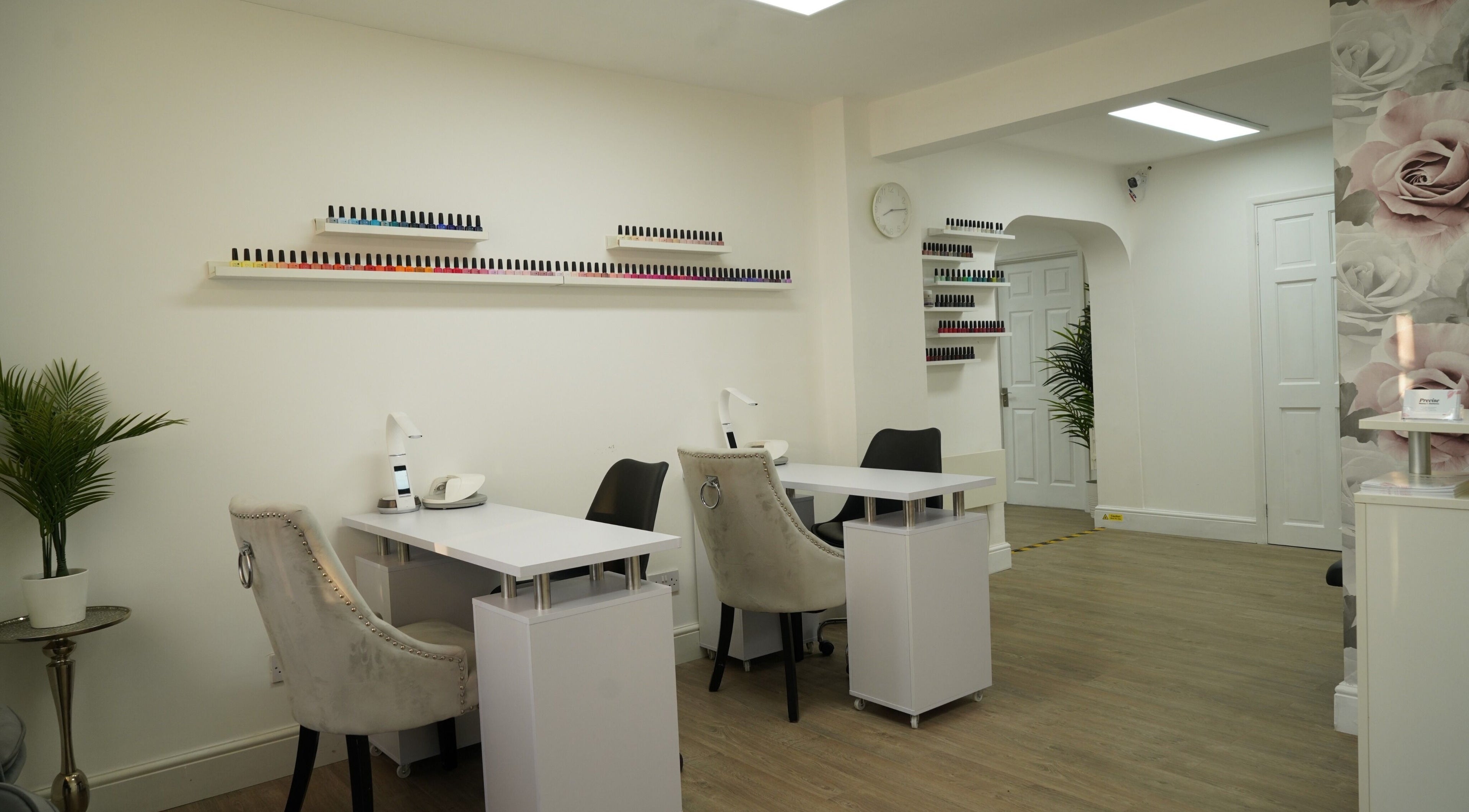 Nail salon interior at Precise, Southampton, England, GB, featuring manicure stations and elegant decor.