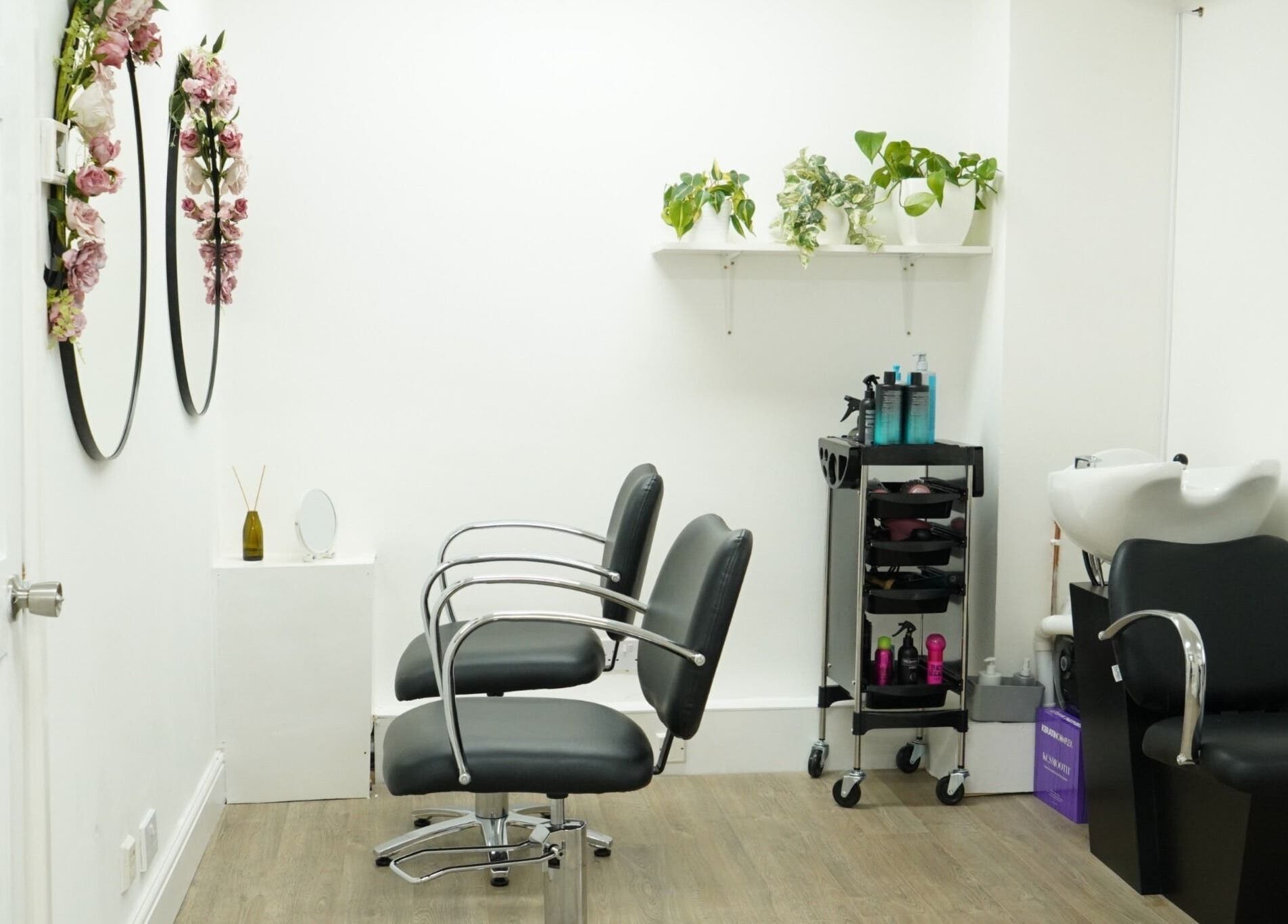 Modern salon interior at Precise in Southampton, England, GB, featuring chic chairs and elegant decor.