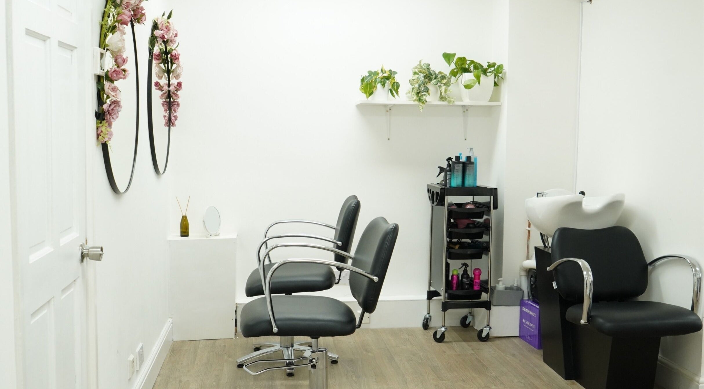 Modern salon interior at Precise in Southampton, England, GB, featuring chic chairs and elegant decor.
