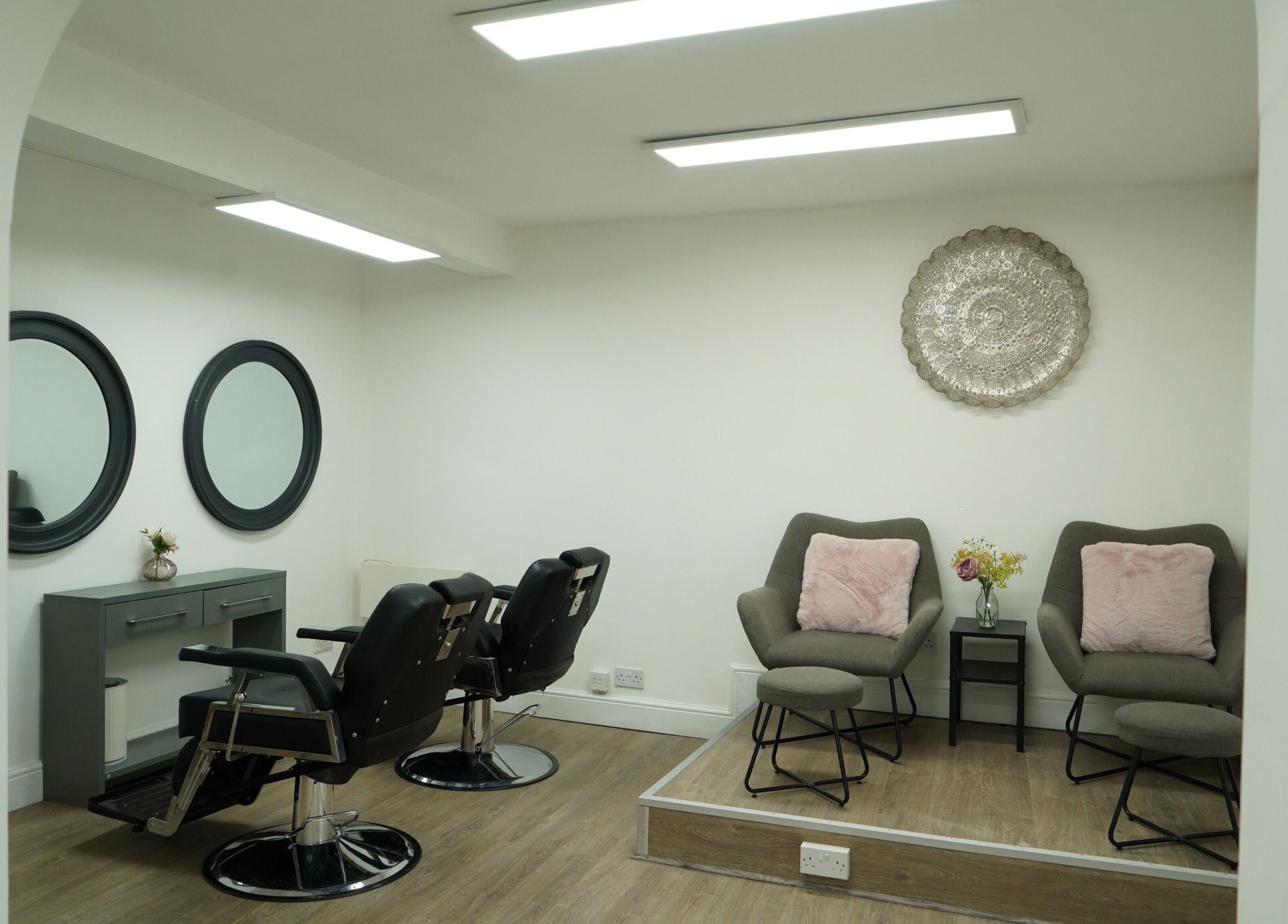 Chic and modern salon interior at Precise, Southampton, England, GB with stylish chairs and mirrors.