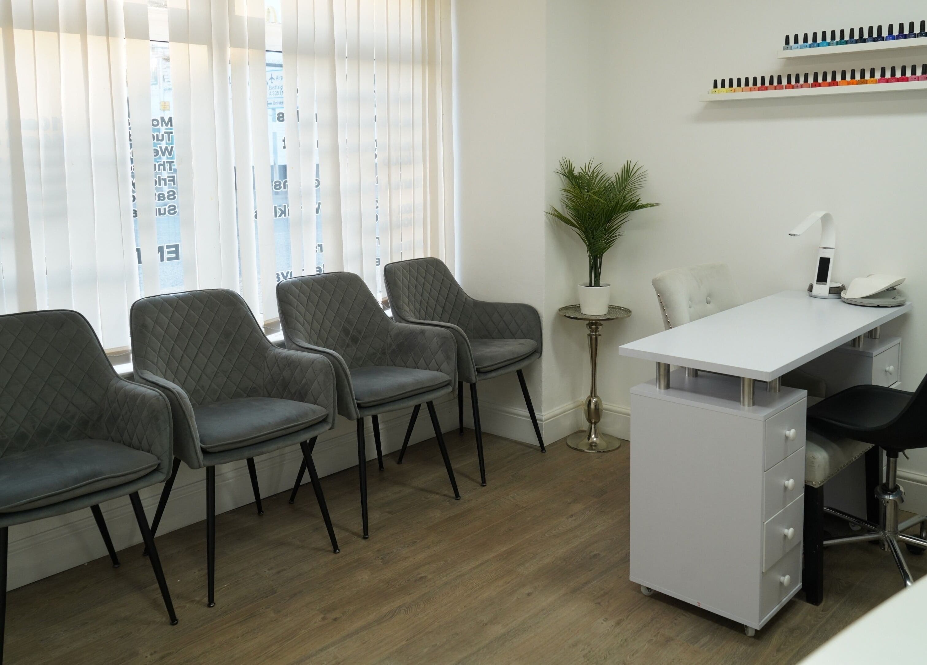 Modern salon waiting area and manicure station at Precise in Southampton, England, GB, featuring stylish seating.