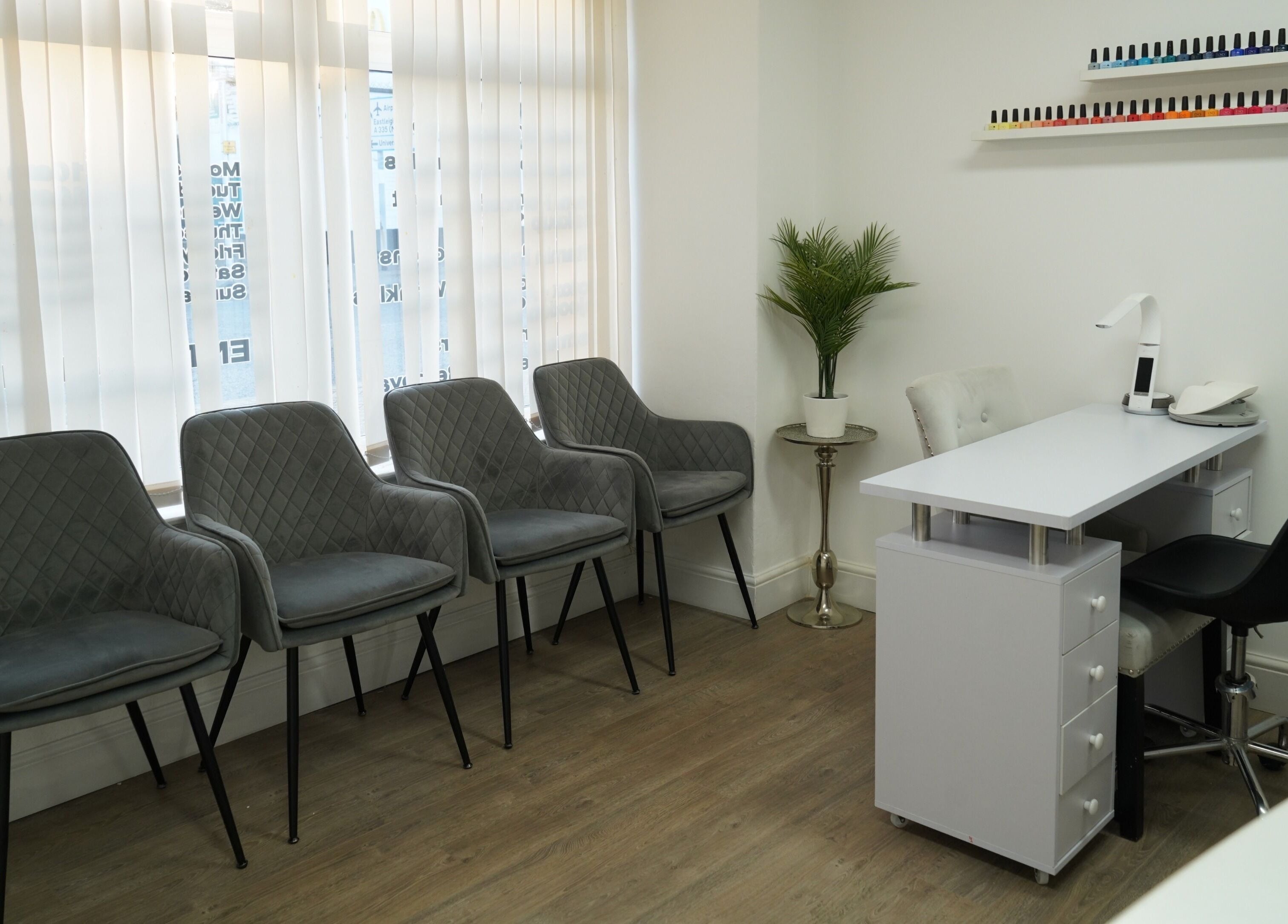 Modern salon waiting area and manicure station at Precise in Southampton, England, GB, featuring stylish seating.