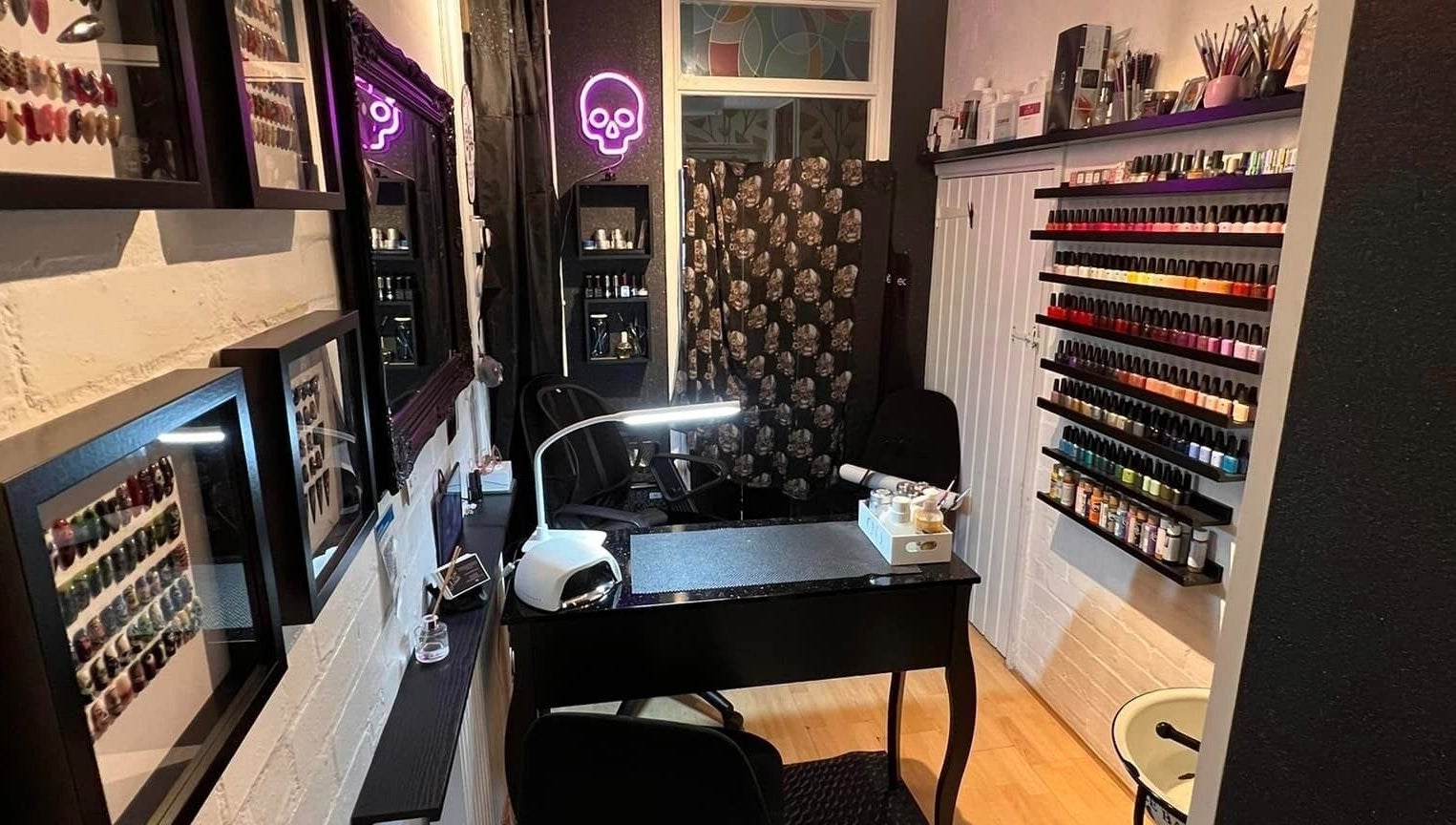 Cozy nail salon interior at Got Nails, Harlow, England, GB with colorful polish display and sleek manicure station.
